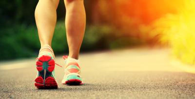 Hiking woman legs wearing sport sneakers