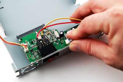 A man examining an electronic component A man examining an electronic component